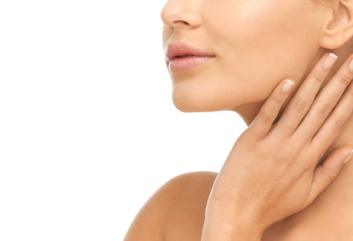 Woman with smooth, glowing skin after a dermaplaning facial.