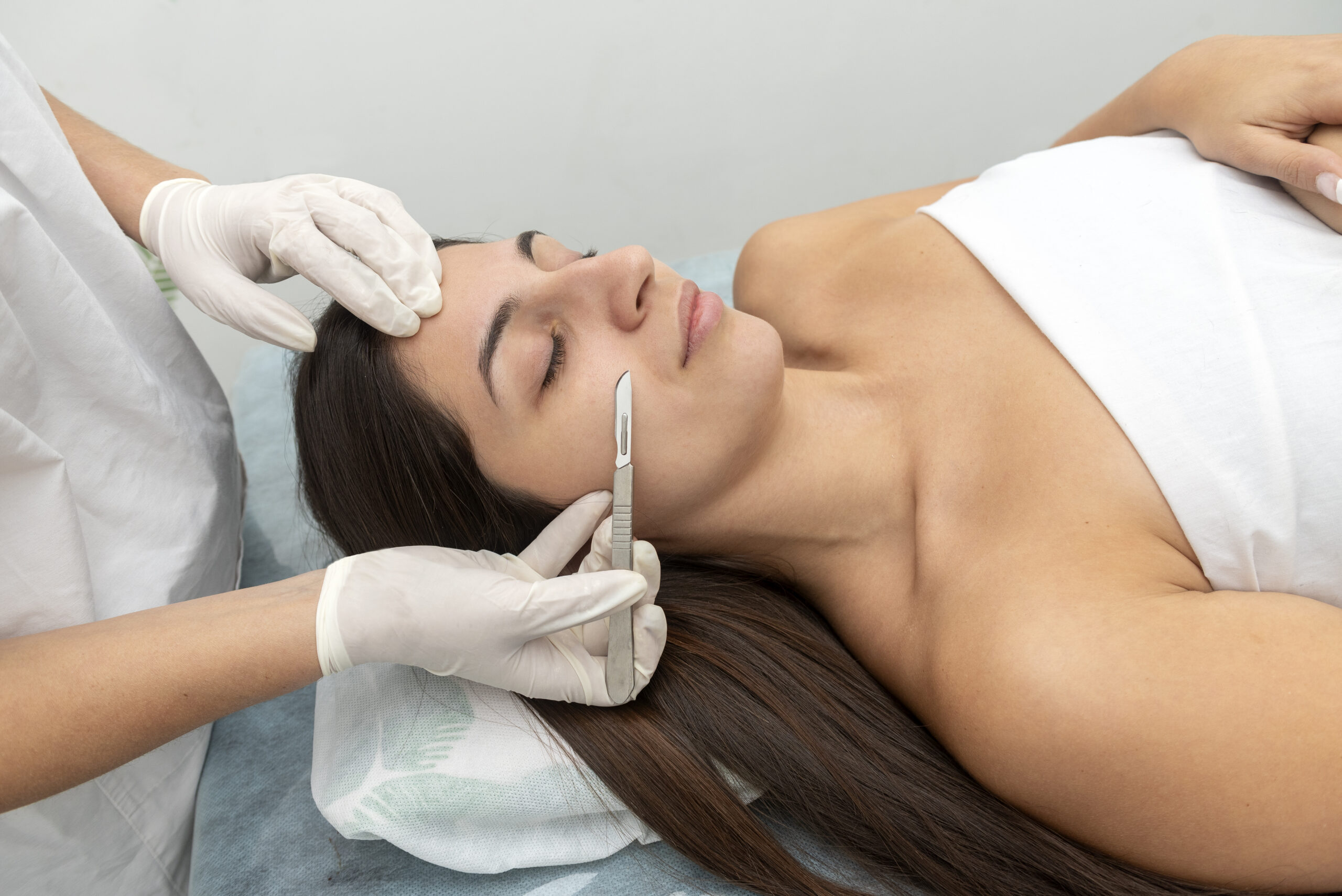 Dermaplaning facial treatment removing dead skin for smoother texture. 
